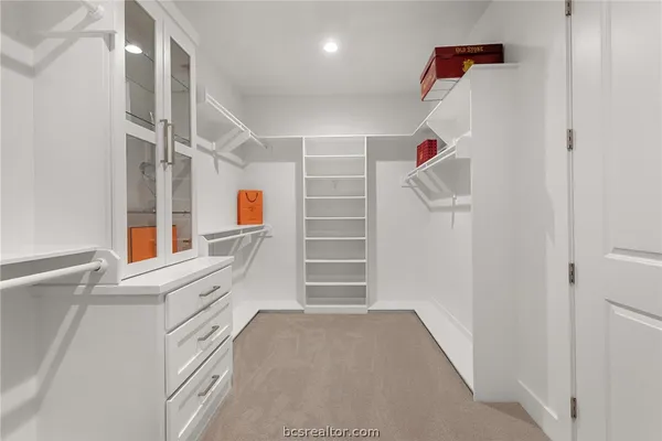 a view of walk in closet with empty racks