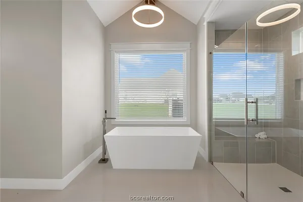 a bathroom with a tub and shower
