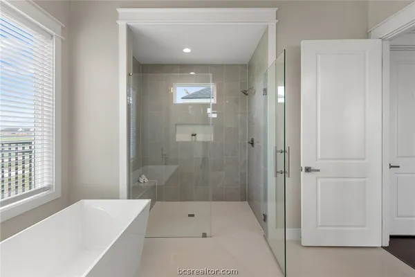 a bathroom with a bathtub and shower