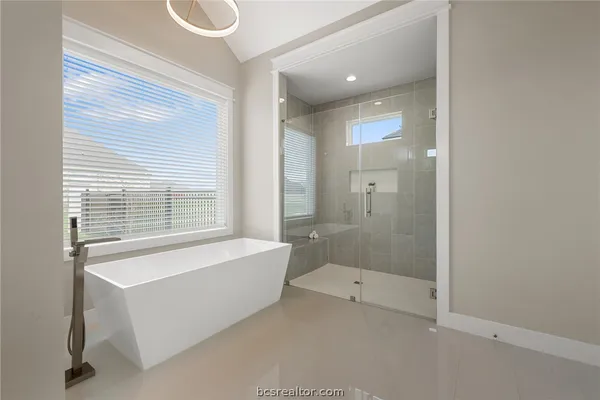 a bathroom with a bathtub and shower