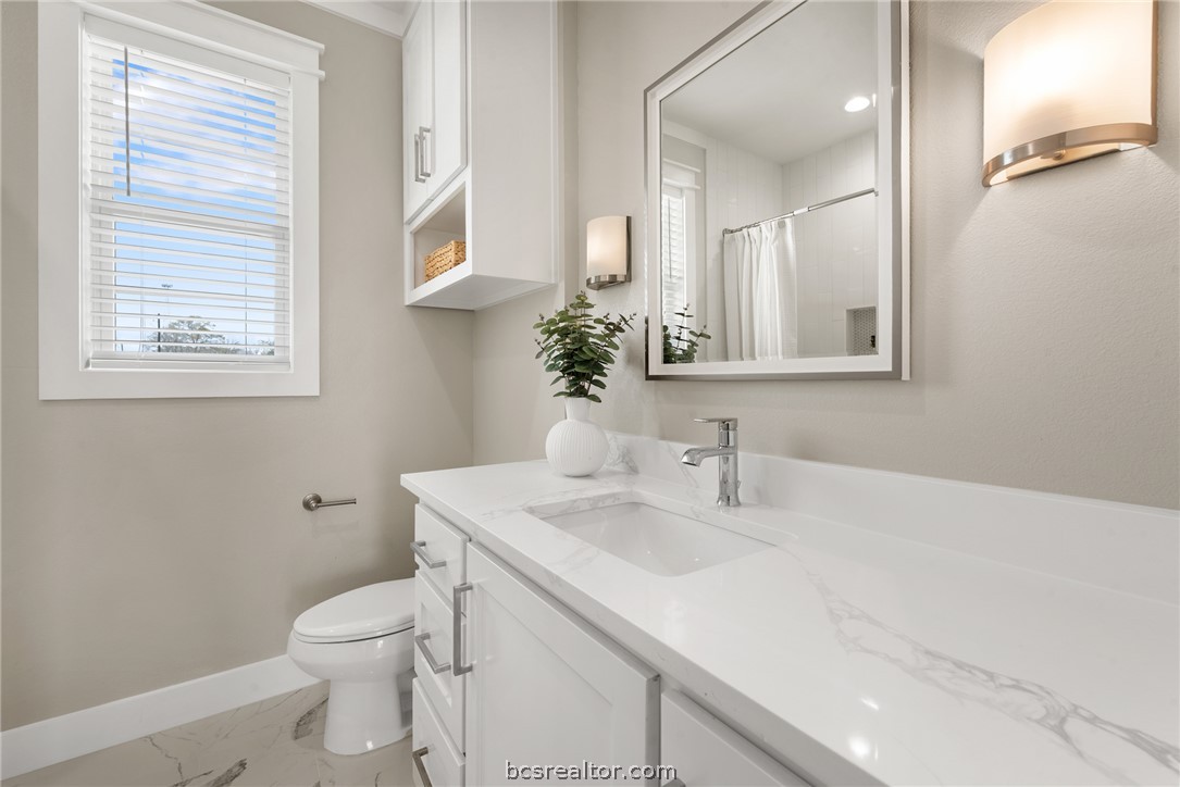 7844 Mathis Crk Drive Bryan, TX 77808 - Photo 35 of 48 a bathroom with a sink toilet and vanity