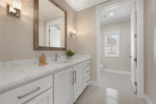 a bathroom with a sink and a mirror