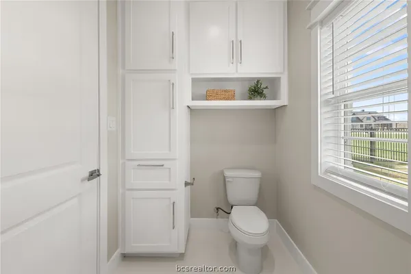 a white toilet sitting next to a bathroom sink