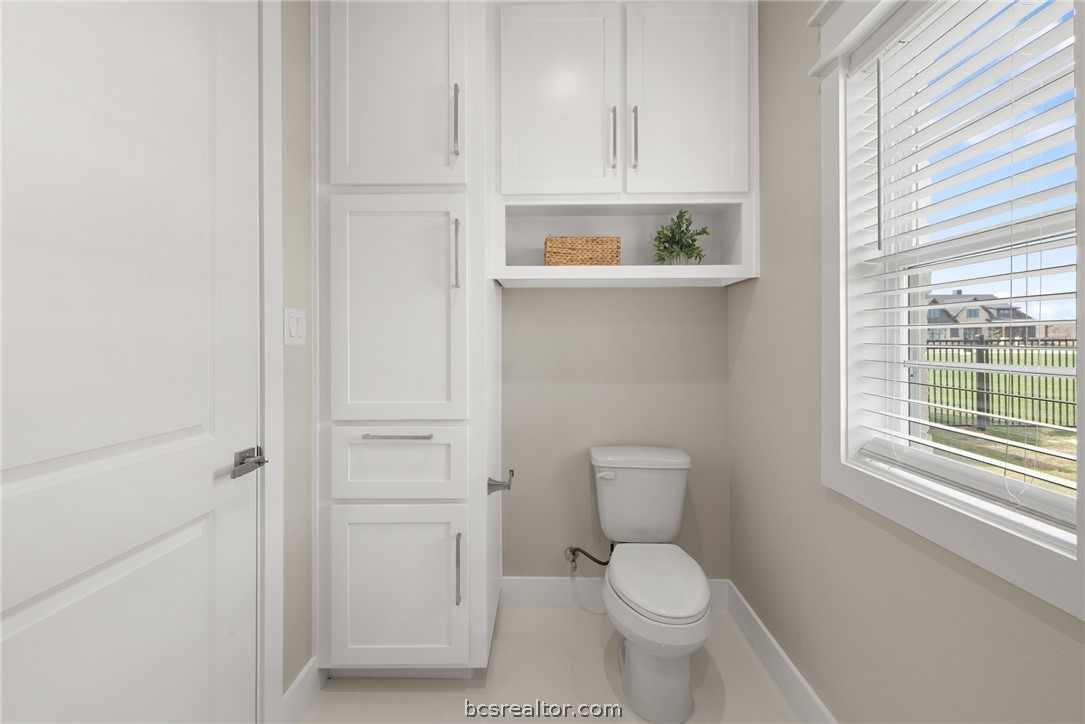 7844 Mathis Crk Drive Bryan, TX 77808 - Photo 41 of 48 a white toilet sitting next to a bathroom sink