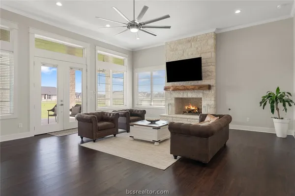 a living room with fireplace furniture and a flat screen tv
