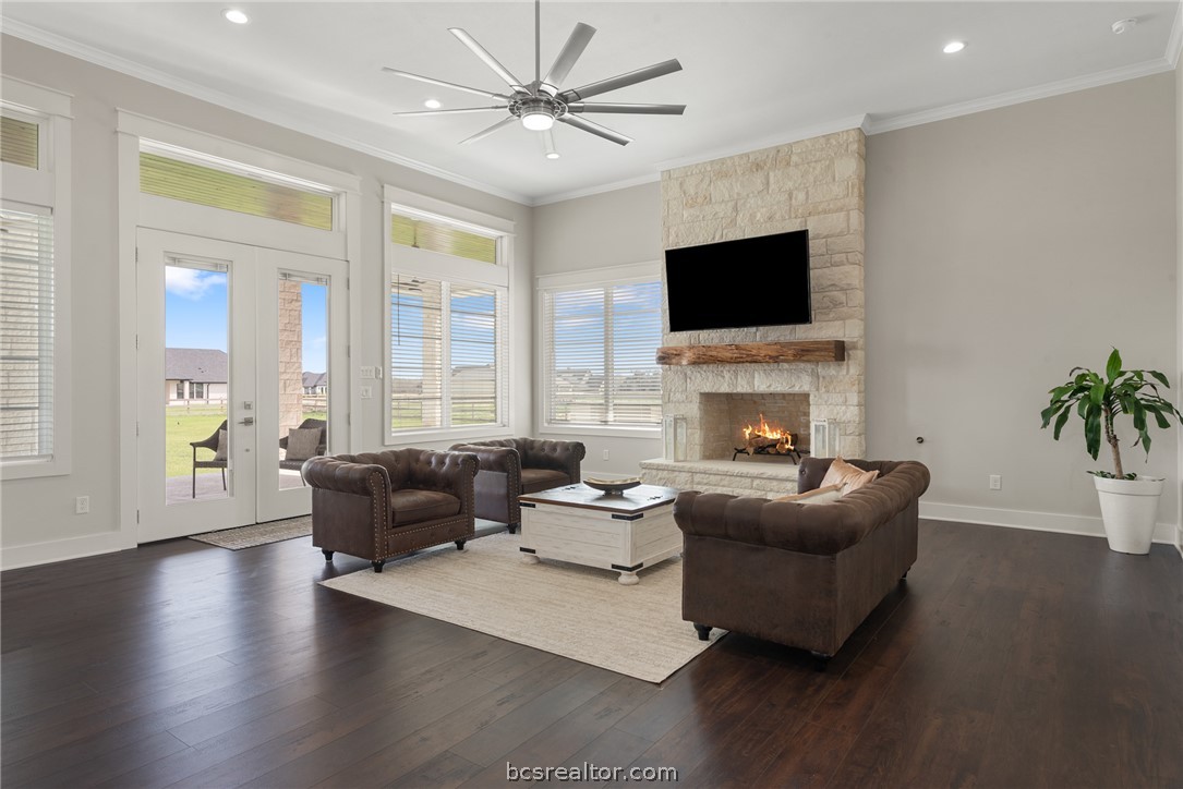7844 Mathis Crk Drive Bryan, TX 77808 - Photo 7 of 48 a living room with fireplace furniture and a flat screen tv