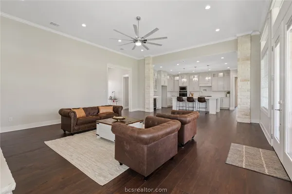 a living room with furniture and a view of kitchen