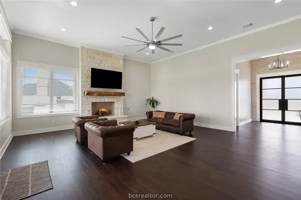 a living room with furniture a flat screen tv and a fireplace