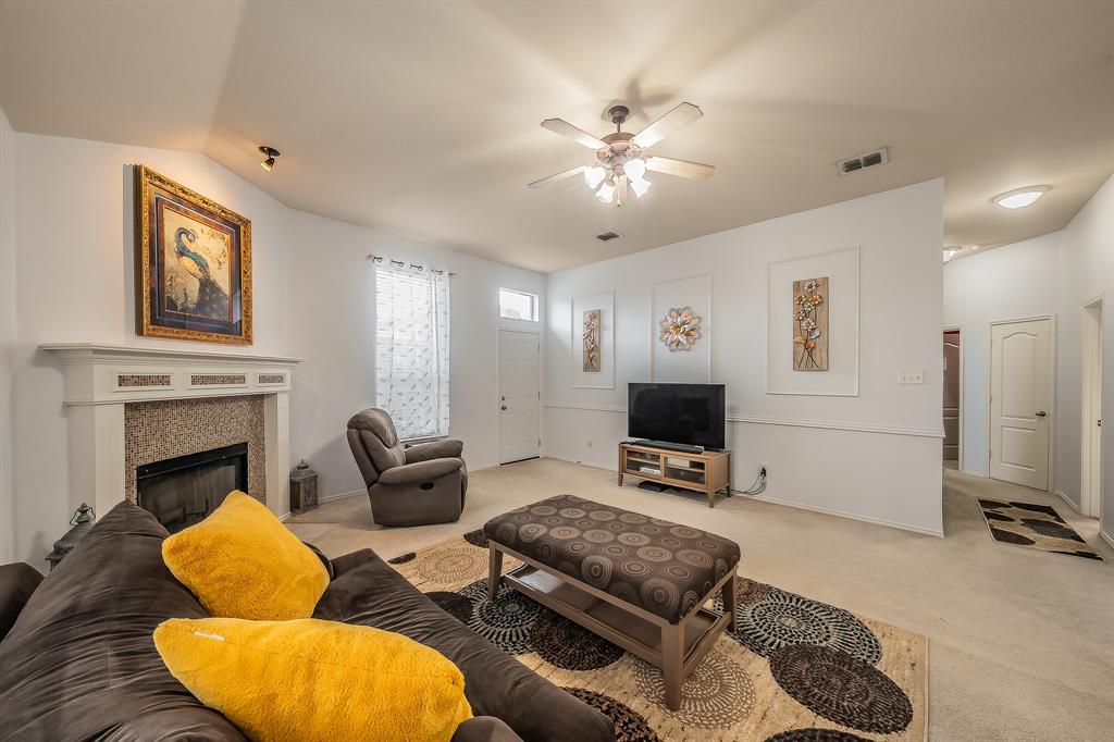 8312 Trinity Vista Trail Hurst, TX 76053 - Photo 15 of 37 Carpeted living room featuring ceiling fan and a fireplace