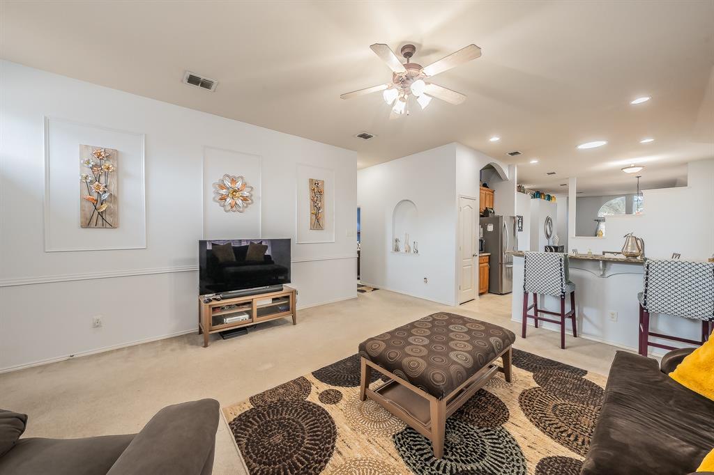 8312 Trinity Vista Trail Hurst, TX 76053 - Photo 19 of 37 Living area featuring ceiling fan, recessed lighting, light carpet, and arched walkways