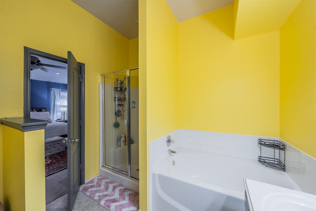 8312 Trinity Vista Trail Hurst, TX 76053 - Photo 25 of 37 Ensuite bathroom featuring a shower stall, a garden tub, vanity, and tile patterned floors