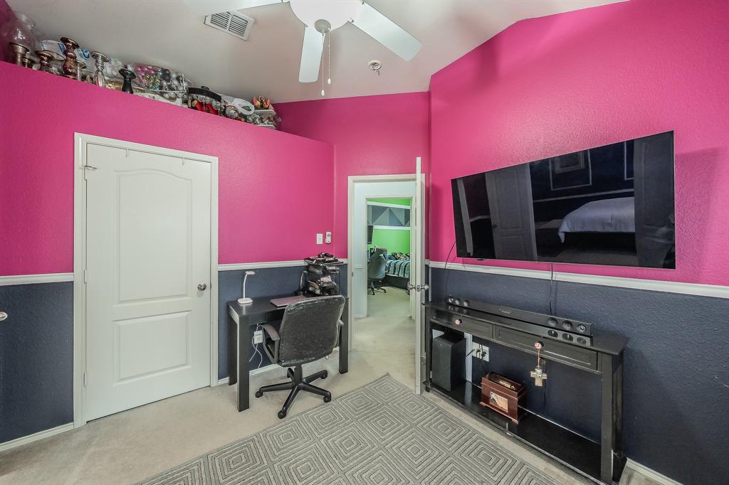 8312 Trinity Vista Trail Hurst, TX 76053 - Photo 27 of 37 Office area with a textured wall, vaulted ceiling, a ceiling fan, and light carpet