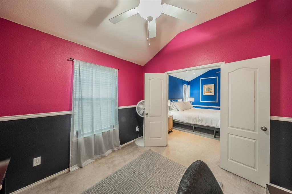 8312 Trinity Vista Trail Hurst, TX 76053 - Photo 29 of 37 Carpeted bedroom with vaulted ceiling, a ceiling fan, and a textured wall