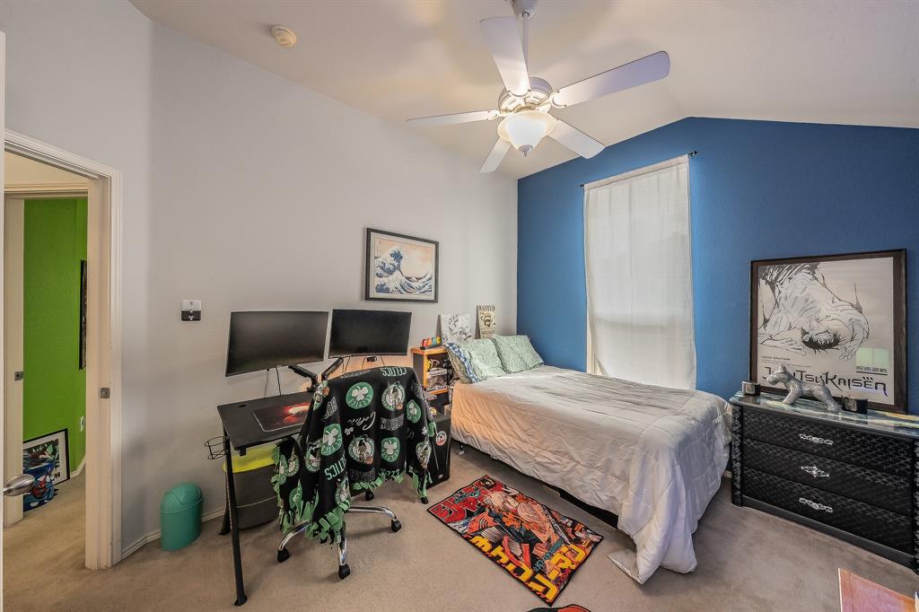 8312 Trinity Vista Trail Hurst, TX 76053 - Photo 31 of 37 Bedroom with carpet, vaulted ceiling, a ceiling fan, and an office area