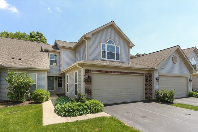 1230 Coldspring Road, Unit 1230 Elgin, IL 60120 - Photo 1 of 21 a front view of a house with a yard and garage