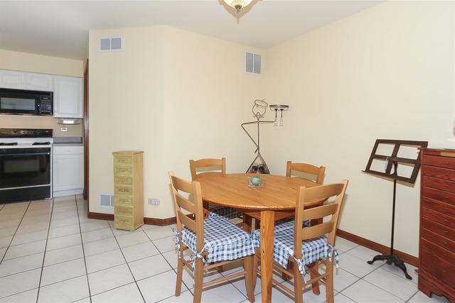 1230 Coldspring Road, Unit 1230 Elgin, IL 60120 - Photo 11 of 21 a view of a dining room with furniture
