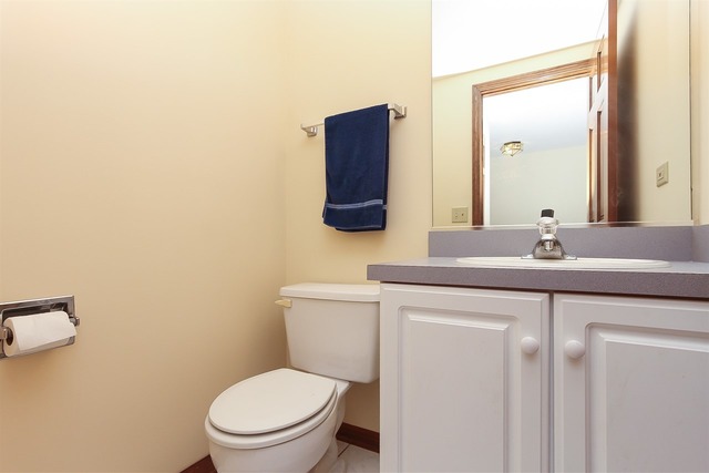 1230 Coldspring Road, Unit 1230 Elgin, IL 60120 - Photo 12 of 21 a bathroom with a toilet a sink and mirror