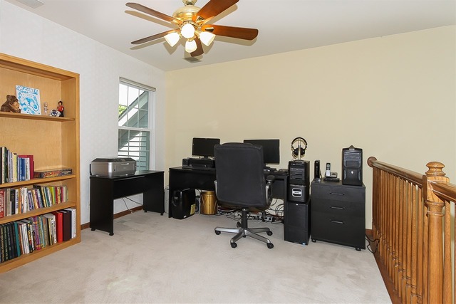 1230 Coldspring Road, Unit 1230 Elgin, IL 60120 - Photo 13 of 21 a view of a workspace with furniture and a bookshelf
