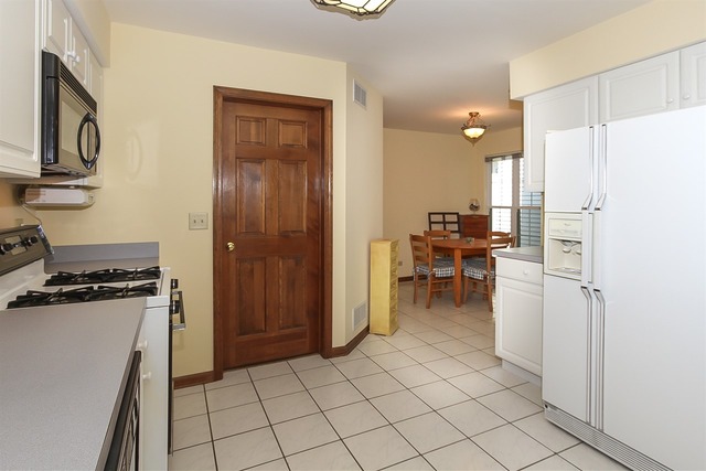 1230 Coldspring Road, Unit 1230 Elgin, IL 60120 - Photo 8 of 21 a kitchen with a refrigerator and a stove