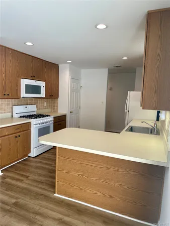 a view of a kitchen with a stove cabinets and wooden floor