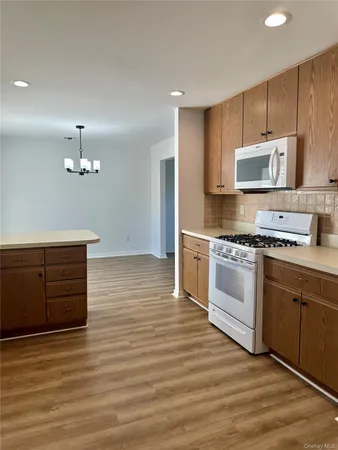 a kitchen with a sink a window and stainless steel appliances
