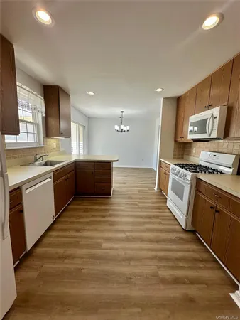 a kitchen with stainless steel appliances a stove top oven and cabinets