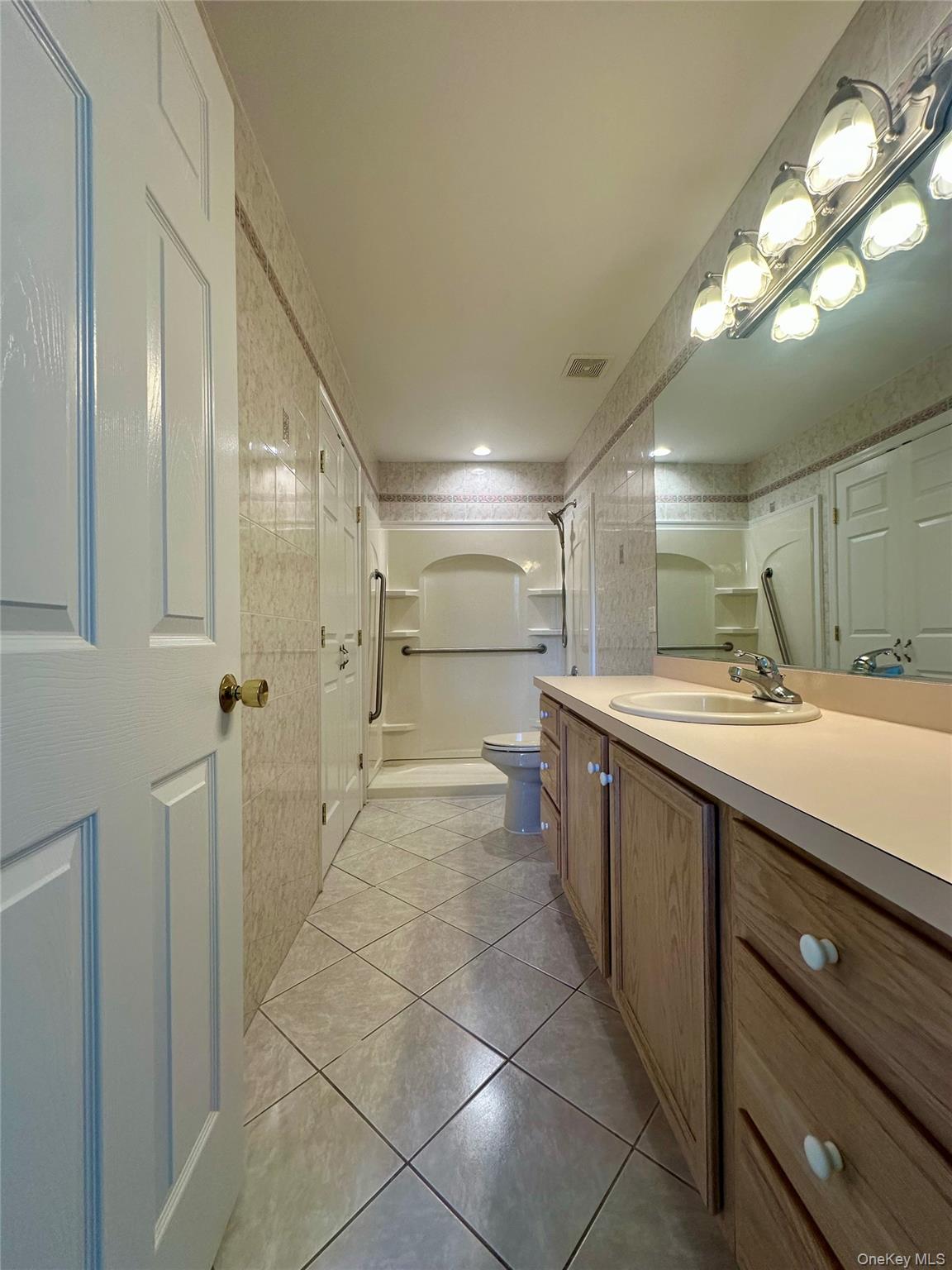 1403 Pebble Beach Path Riverhead, NY 11901 - Photo 19 of 35 Primary Bathroom with linen closet for storage.
