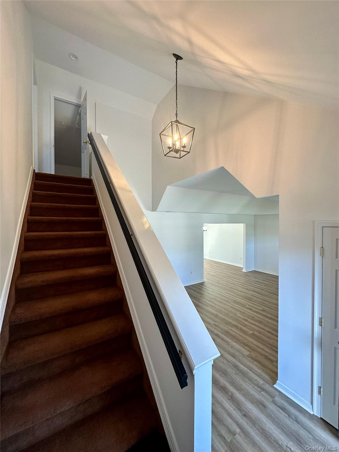 1403 Pebble Beach Path Riverhead, NY 11901 - Photo 35 of 35 Stairway to upstairs second bedroom, and open floorplan into the main living room.