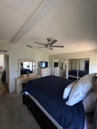 a bedroom with a bed window and dresser