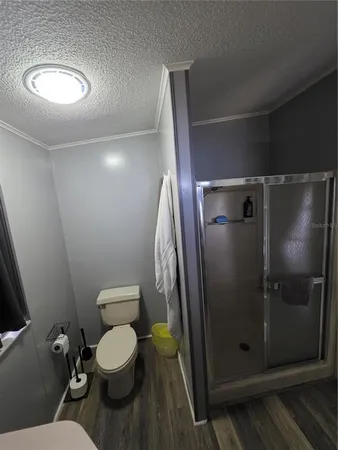 a bathroom with a toilet and a shower