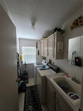 a kitchen with a sink stove and cabinets