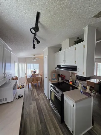 a kitchen that has a lot of cabinets in it