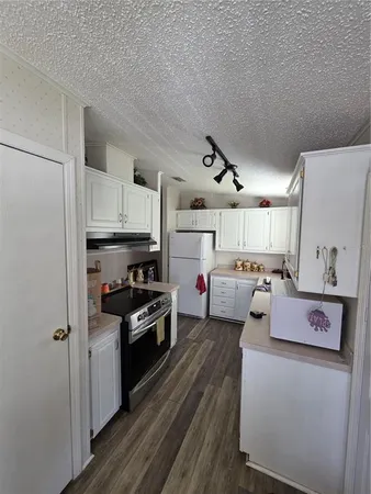 a kitchen with stainless steel appliances granite countertop a stove a refrigerator and a refrigerator