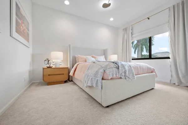 a bedroom with bed and window