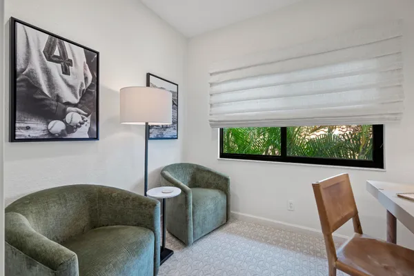 a living room with furniture a window and a flat screen tv