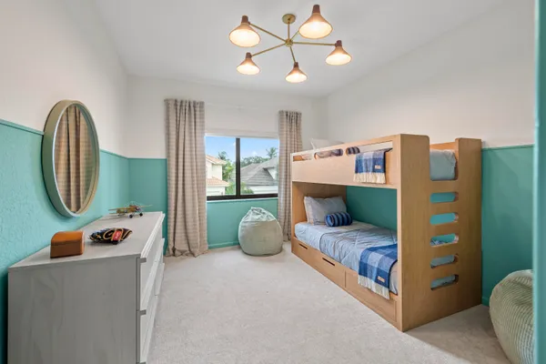 a bedroom with a bed and a chandelier