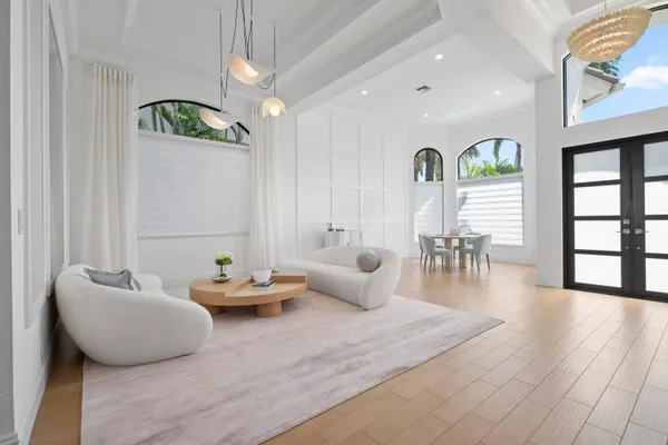 a living room with furniture and wooden floor