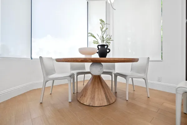 a dining room with furniture and window