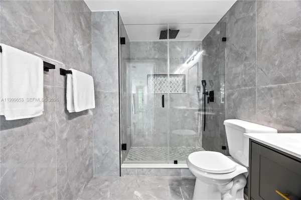 a bedroom with a bed and a shower