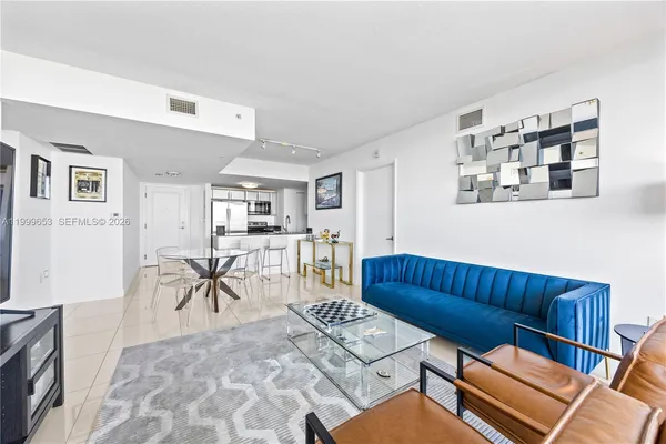 a living room with furniture a rug and a flat screen tv
