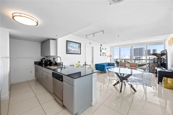 a kitchen with a sink and chairs