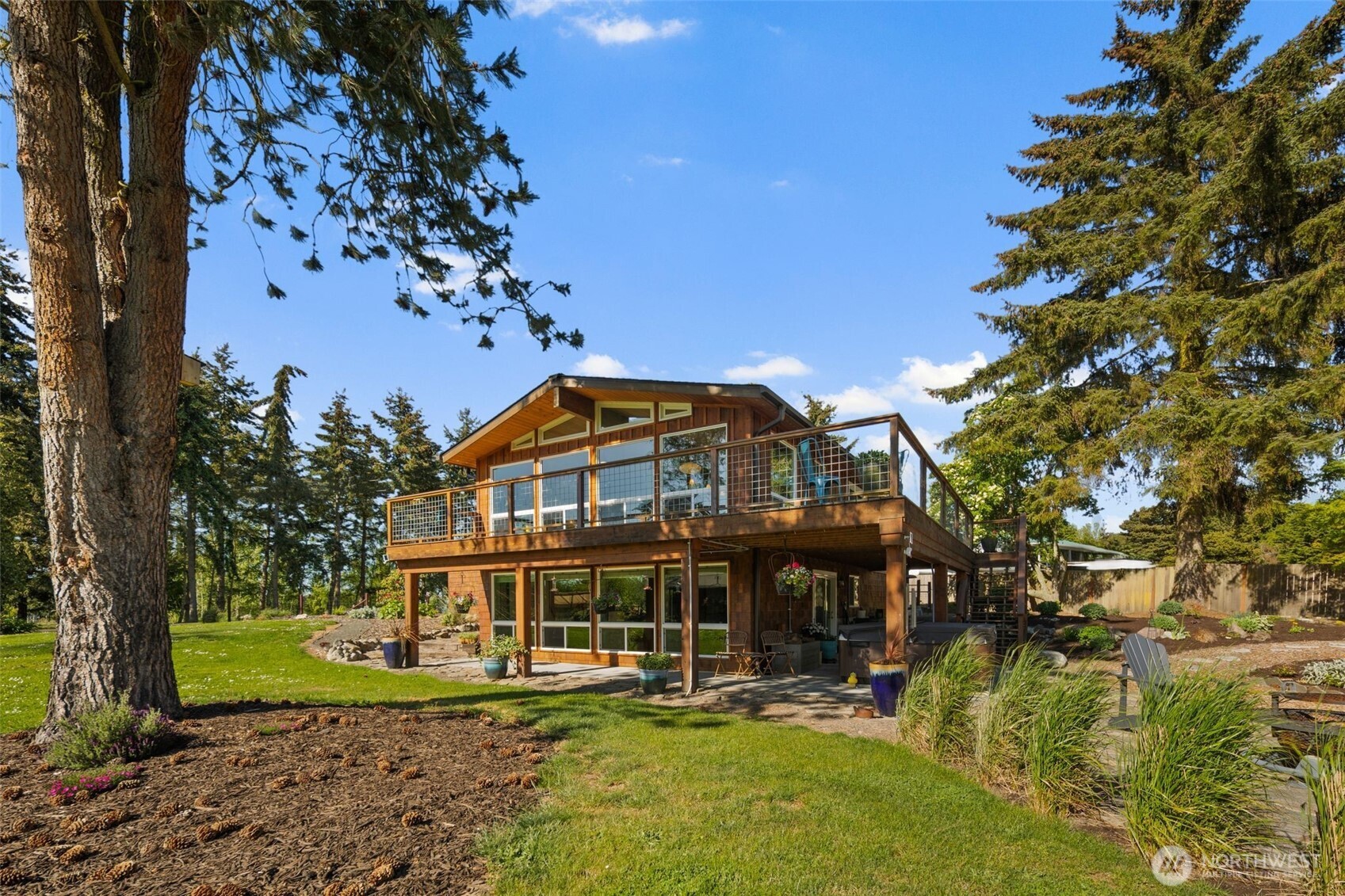 734 Shore Road Port Angeles, WA 98362 - Photo 1 of 40 a view of a big house with a big yard and large trees