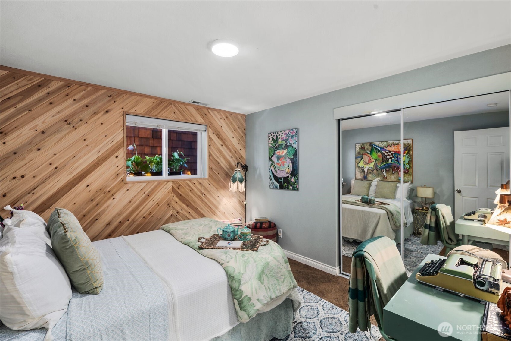 734 Shore Road Port Angeles, WA 98362 - Photo 25 of 40 a bedroom with a bed and wooden floor