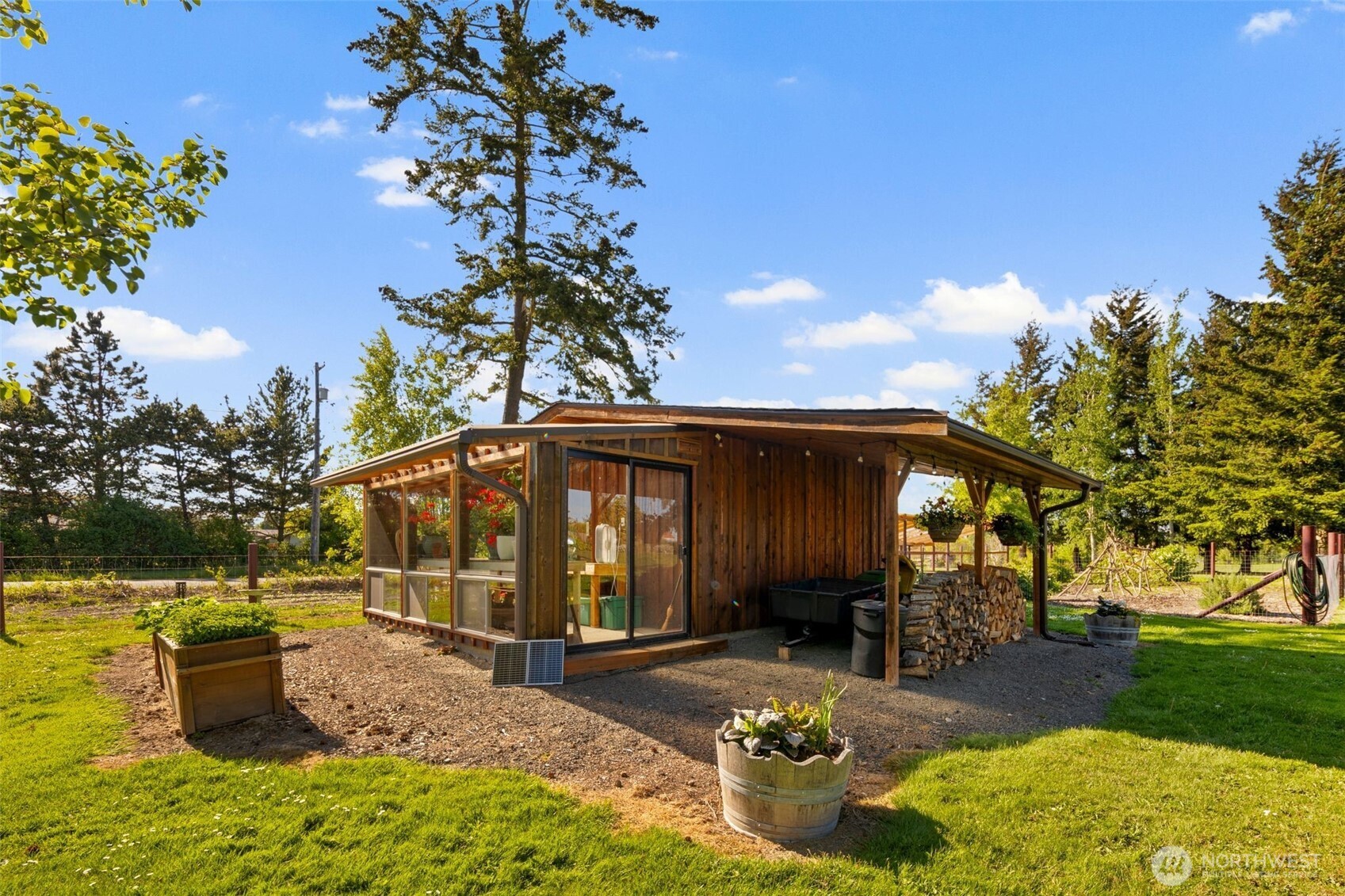 734 Shore Road Port Angeles, WA 98362 - Photo 32 of 40 a view of a patio with table and chairs potted plants and large tree