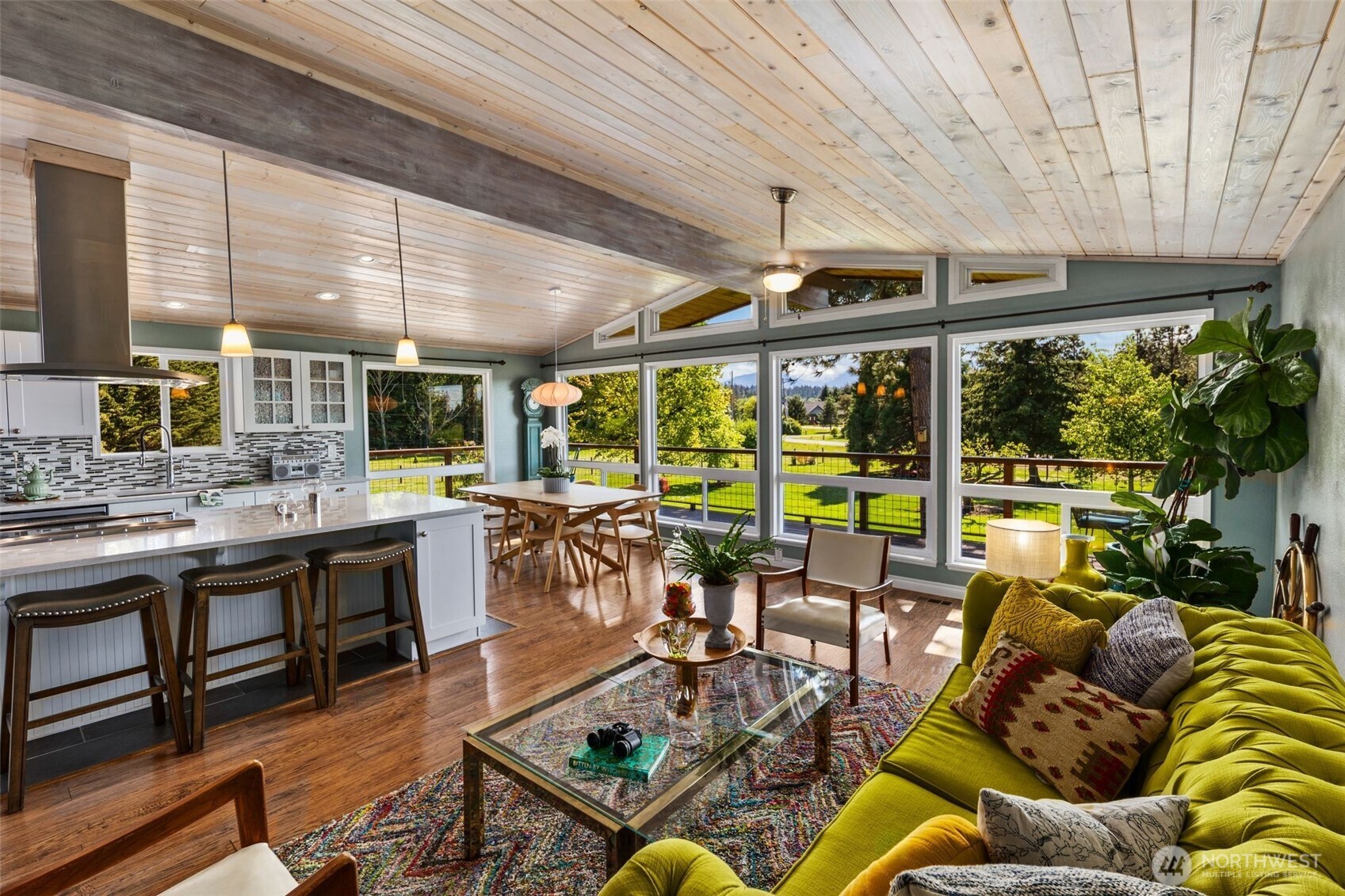 734 Shore Road Port Angeles, WA 98362 - Photo 4 of 40 a living room with lots of furniture wooden floor and outdoor seating