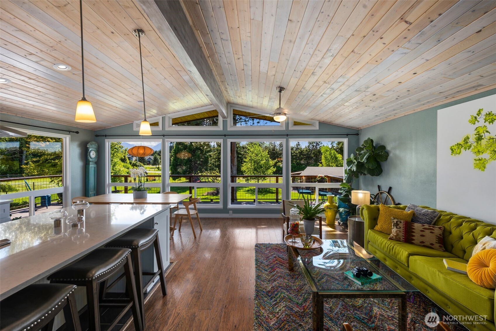 734 Shore Road Port Angeles, WA 98362 - Photo 5 of 40 a living room with furniture a flat screen tv and floor to ceiling windows