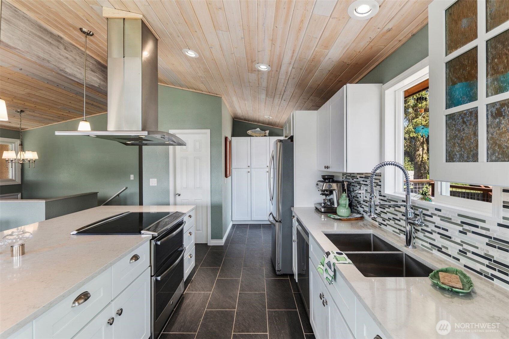 734 Shore Road Port Angeles, WA 98362 - Photo 10 of 40 a kitchen with stainless steel appliances a sink stove and cabinets