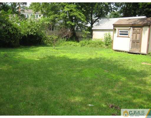 15 Mercury Road Edison, NJ 08817 - Photo 3 of 10 a view of backyard of house with green space