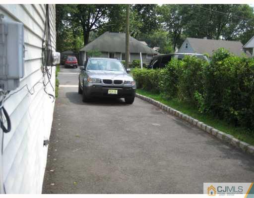 15 Mercury Road Edison, NJ 08817 - Photo 4 of 10 a car parked in front of a house