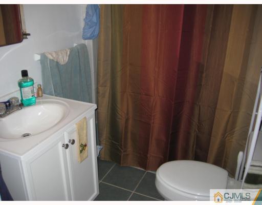15 Mercury Road Edison, NJ 08817 - Photo 10 of 10 a bathroom with a sink toilet and shower